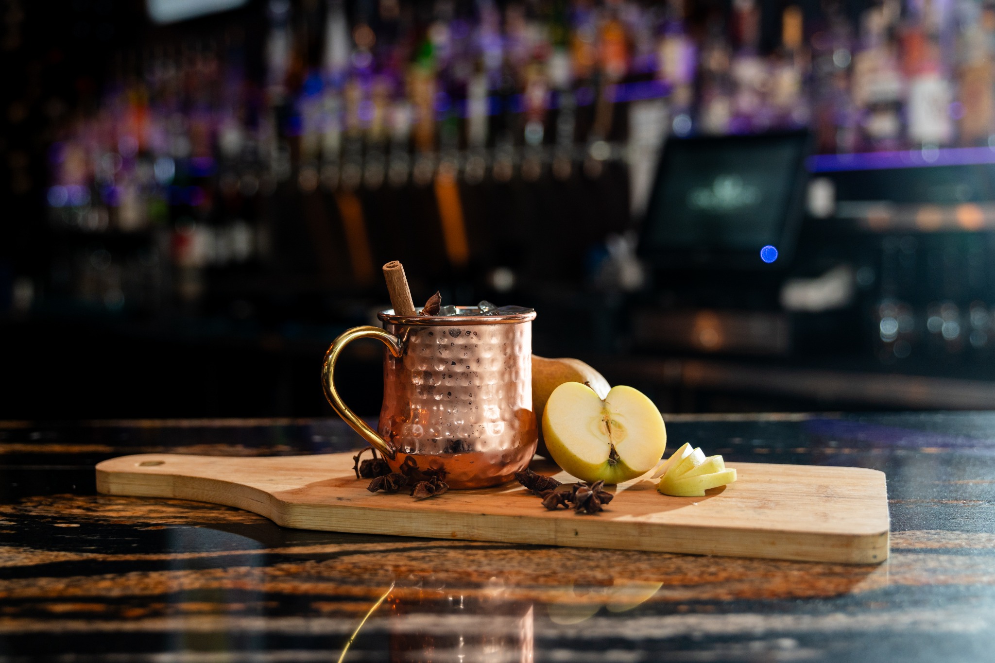 Copper mug cocktail with apple garnish at the One Eighty Hunter bar